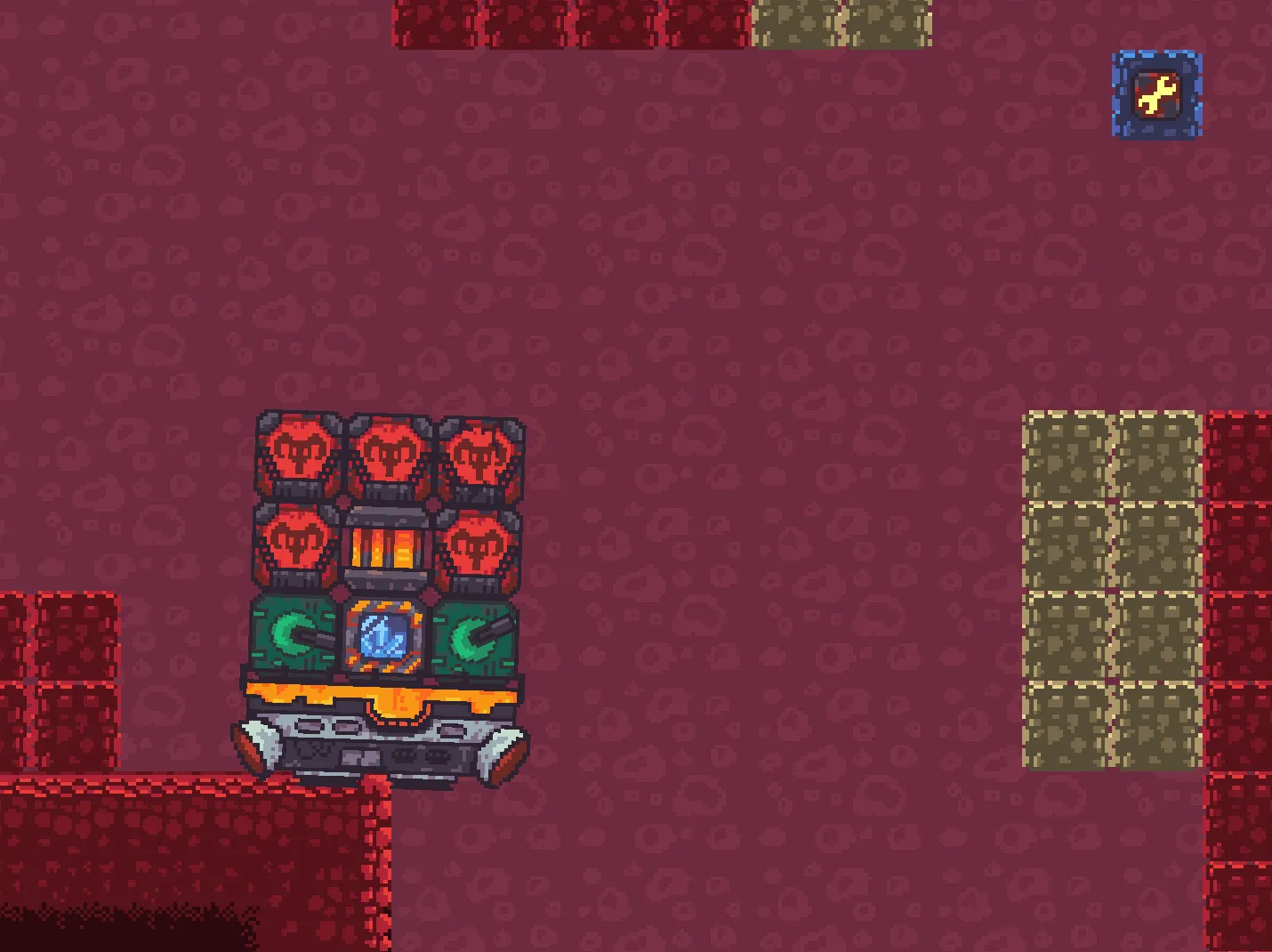 A part of a pixel art level: a block vehicle stands on the edge of a red ledge. On the right are a column of blocks and a repair block.